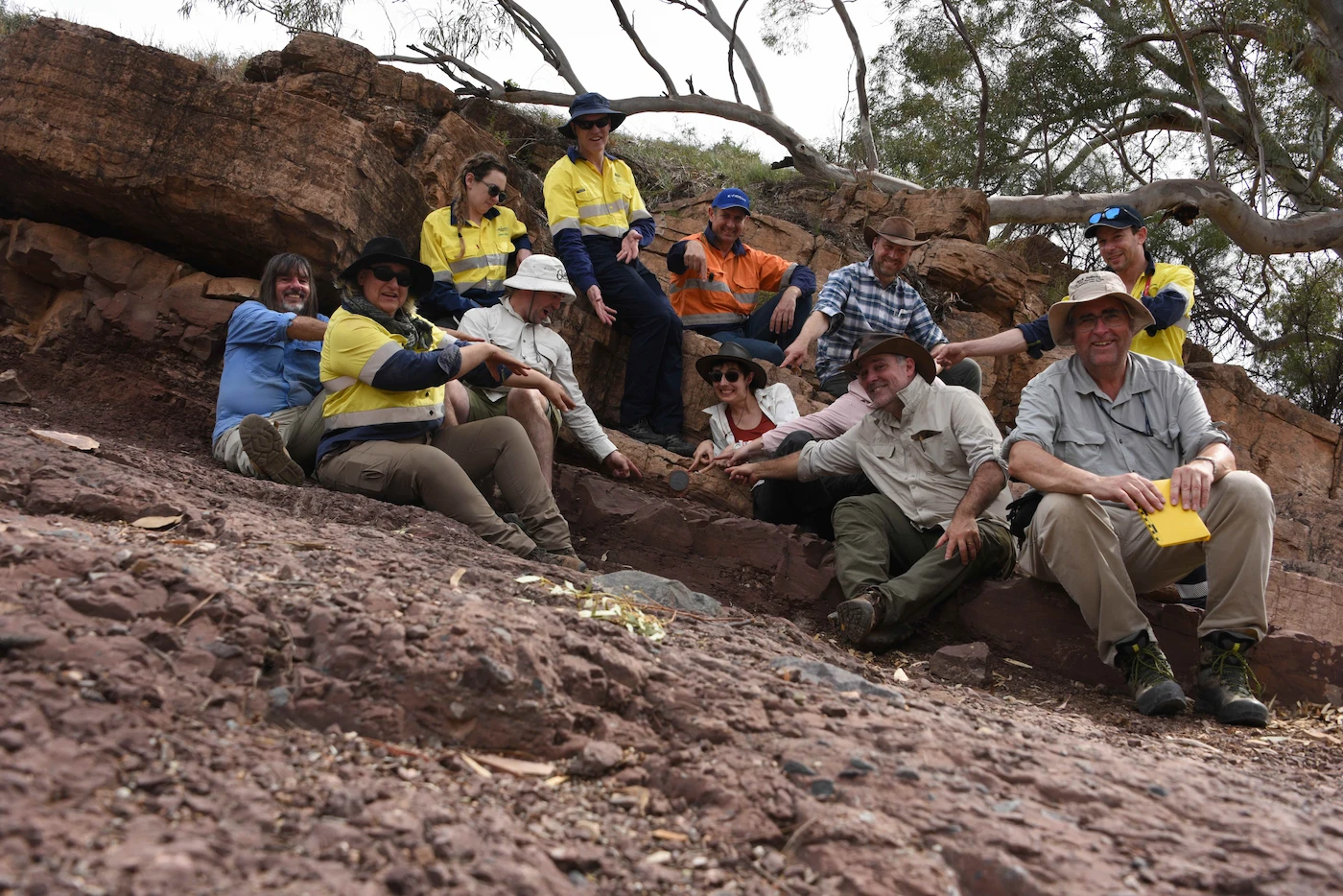A group of AAG members gathered on a rocky outcrop during a symposium field excursion