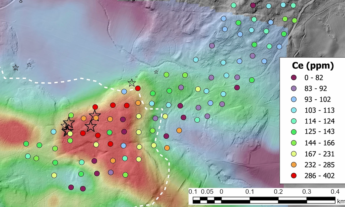 Geochemical map showing cerium concentrations in ppm as colour-coded sample points over a terrain hillshade, with drill targets marked as stars