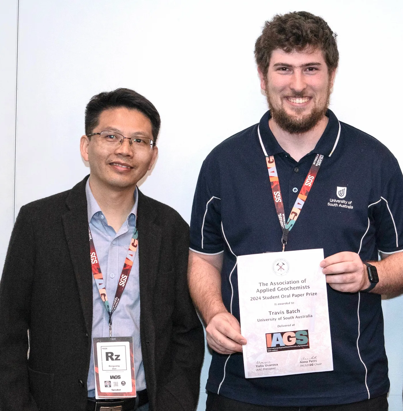 Travis Batch, winner of the AAG 2024 Student Oral Paper Prize, holding his certificate alongside IAGS speaker Ronguang Zan